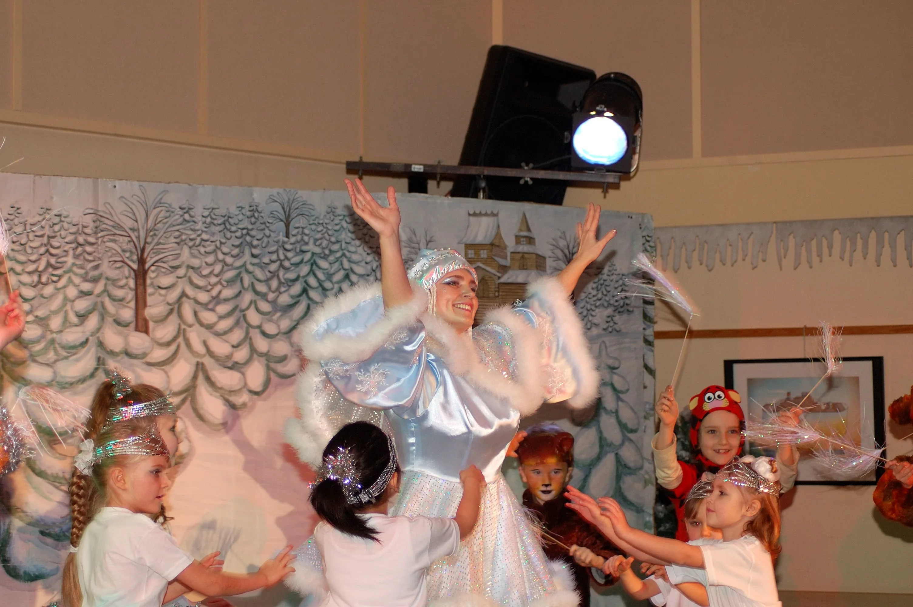 Cette photo magique capture l'essence même du théâtre pour enfants. Une comédienne talentueuse guide des enfants costumés dans une